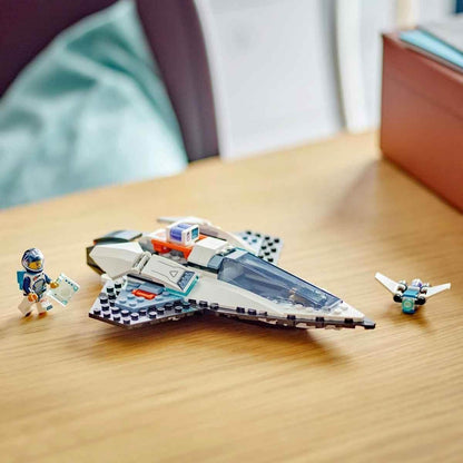 LEGO spaceship toy set with astronaut minifigure and small drone on wooden table