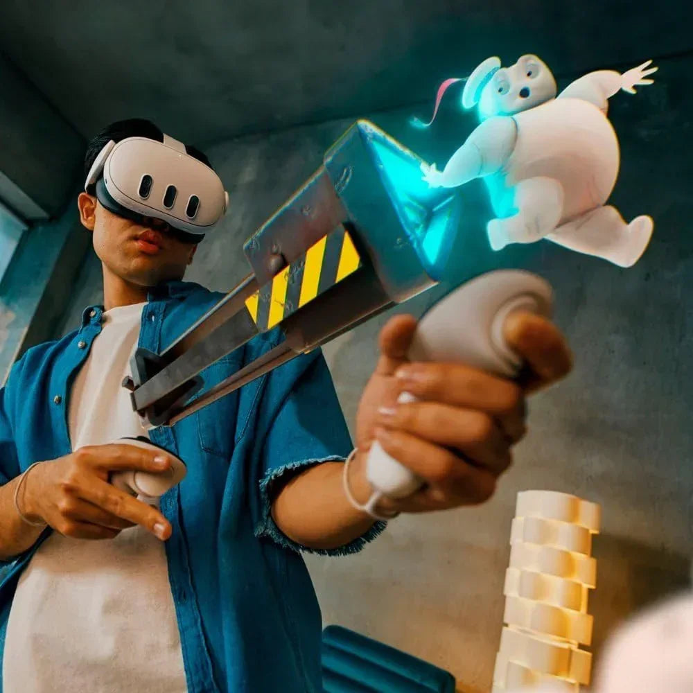 Person using VR headset and controllers with ghost-catching toy blaster and cartoon ghost figure.