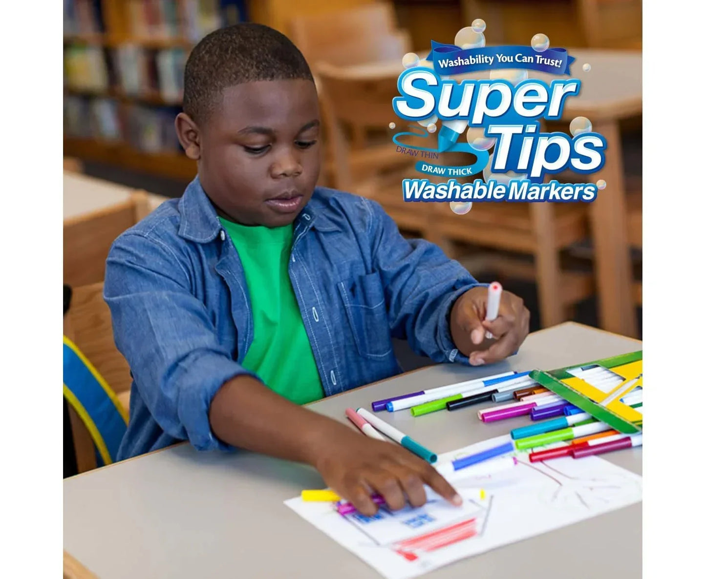 Child drawing with colorful Super Tips washable markers in a classroom setting