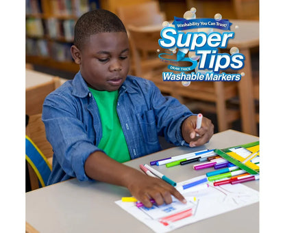 Child drawing with colorful Super Tips washable markers in a classroom setting