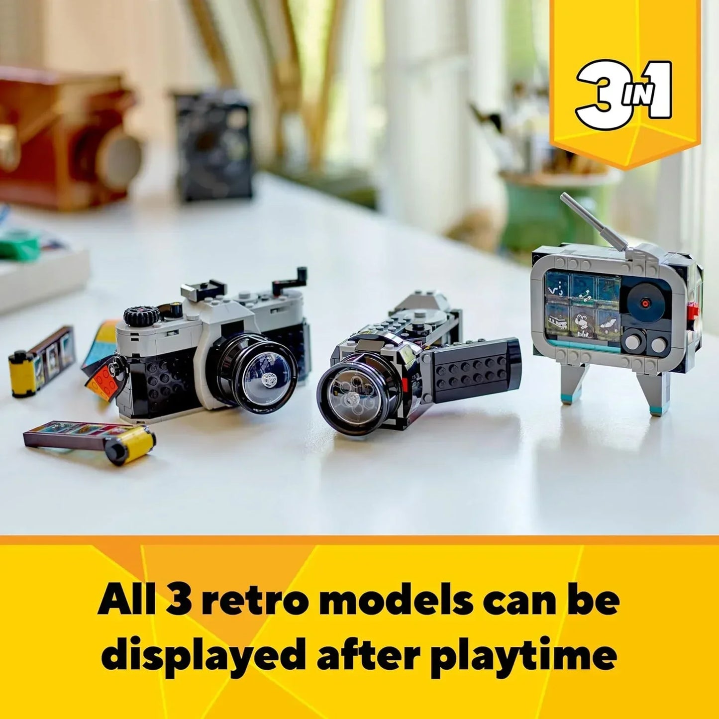 LEGO retro set featuring buildable vintage camera, camcorder, and TV models on a table.