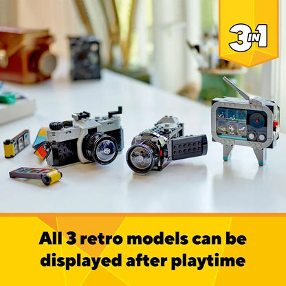 LEGO retro set featuring buildable vintage camera, camcorder, and TV models on a table.