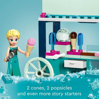 LEGO ice cream shop building set with mini doll figure holding ice cream cone, toy cart, and accessories.