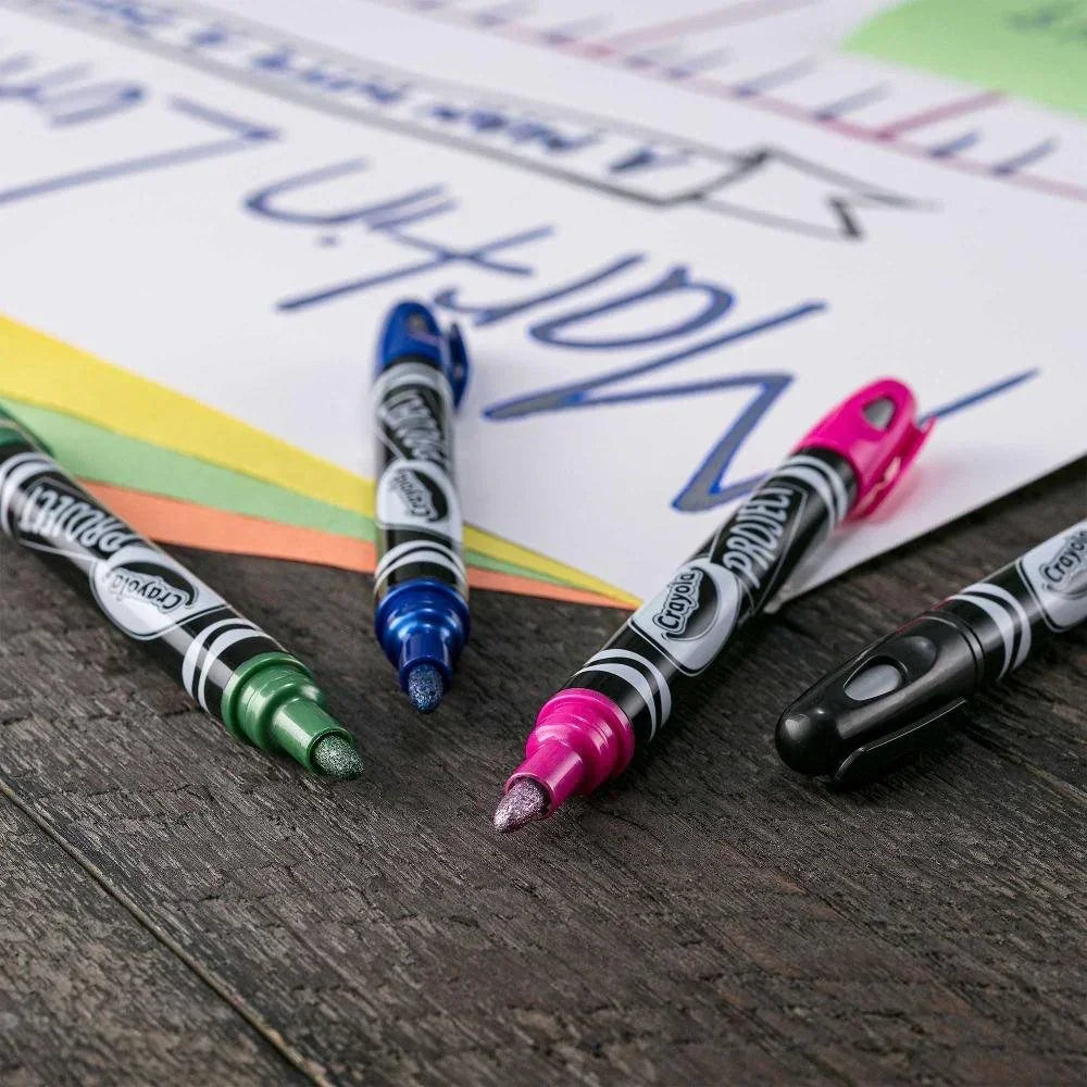 Metallic outline markers in green, blue, pink, and black on paper for arts and crafts.