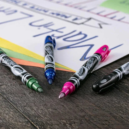 Metallic outline markers in green, blue, pink, and black on paper for arts and crafts.