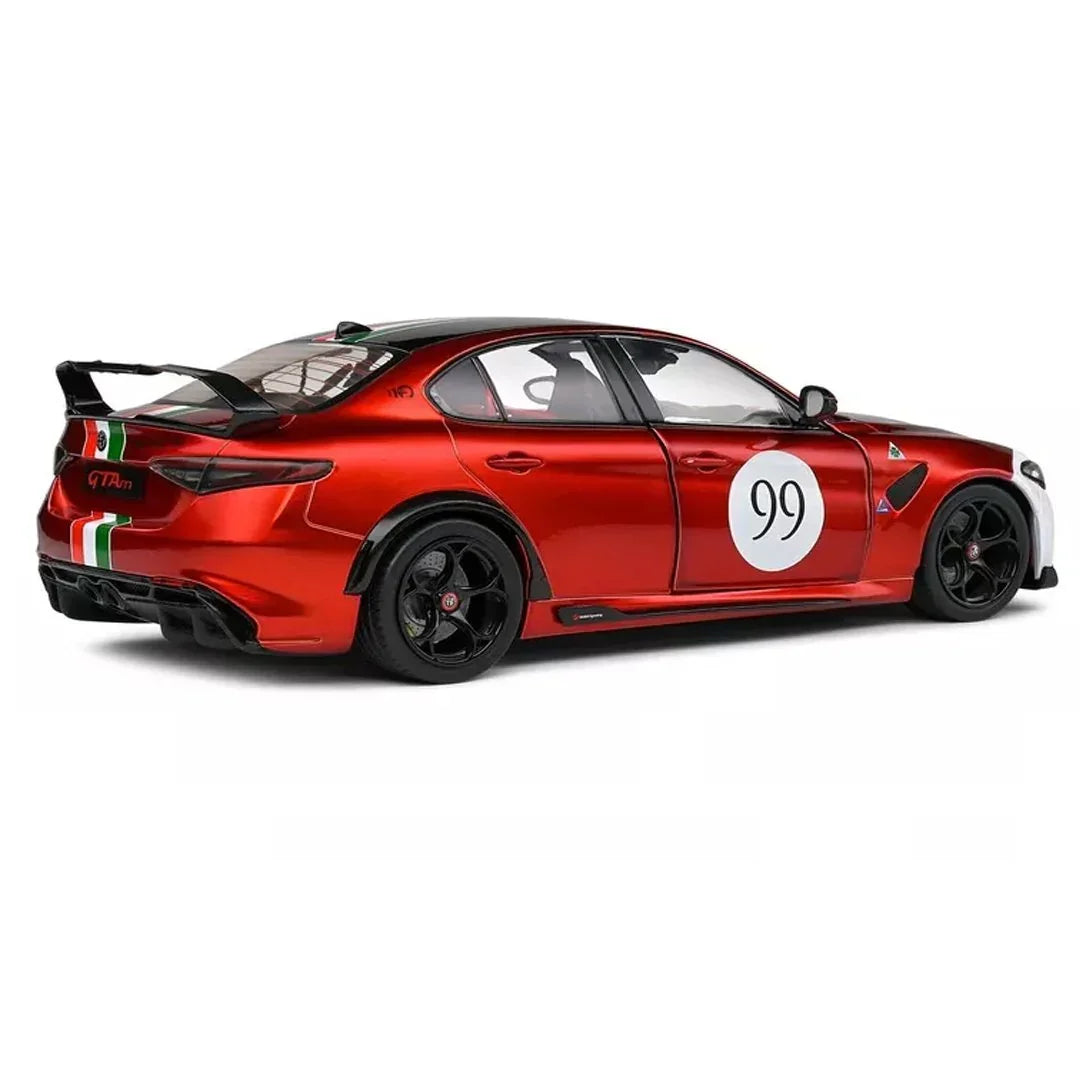 Red diecast collectible car model with racing decals and rear spoiler on white background