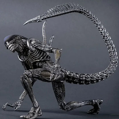 Highly detailed alien action figure with long tail and biomechanical features on display.