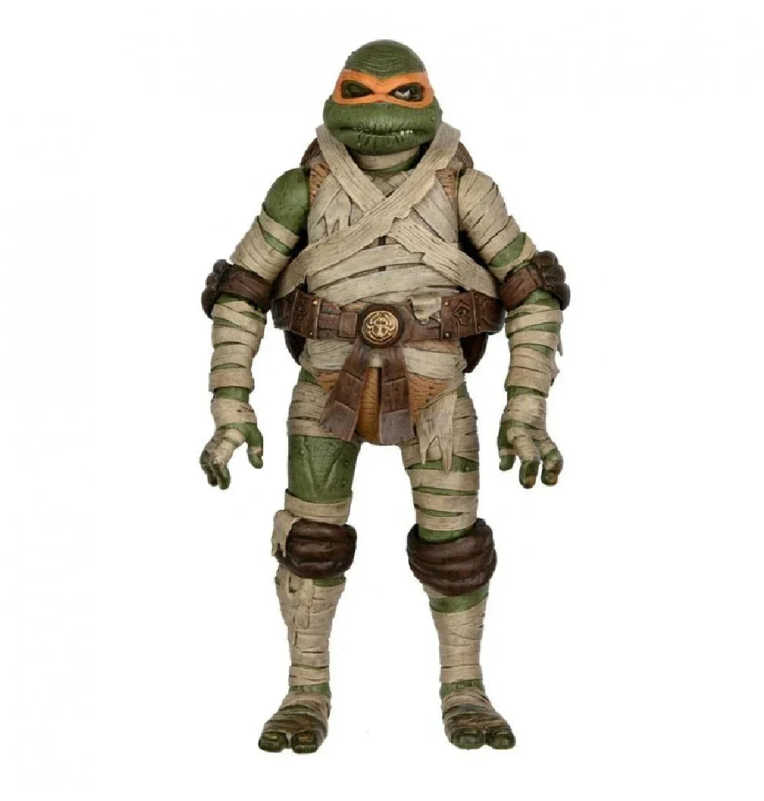Action figure of a green ninja turtle wrapped in bandages with an orange mask and belt