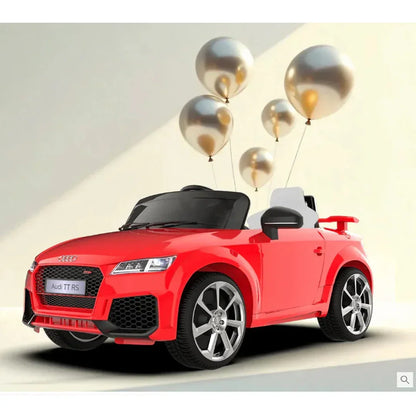 Red toy Audi car with gold balloons on a light gray background