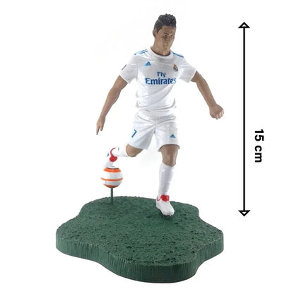 Soccer player action figure in white uniform with ball on green base, 15 cm tall