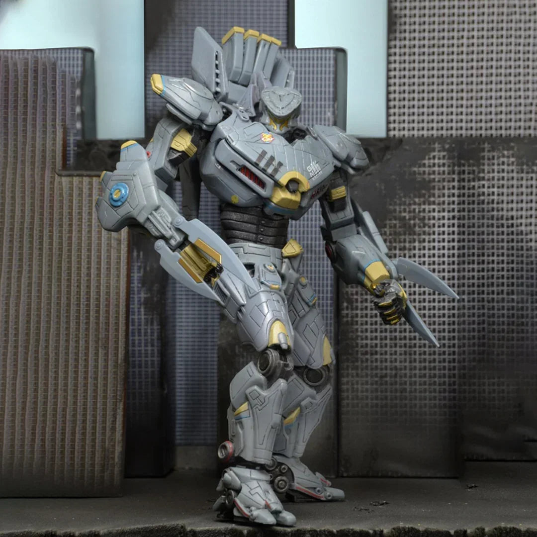 Gray and gold robot action figure with blade arms posed in a cityscape setting