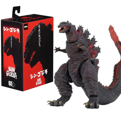 Shin Godzilla action figure with detailed red and black body, posed beside its box featuring Japanese text and Godzilla silhouette.
