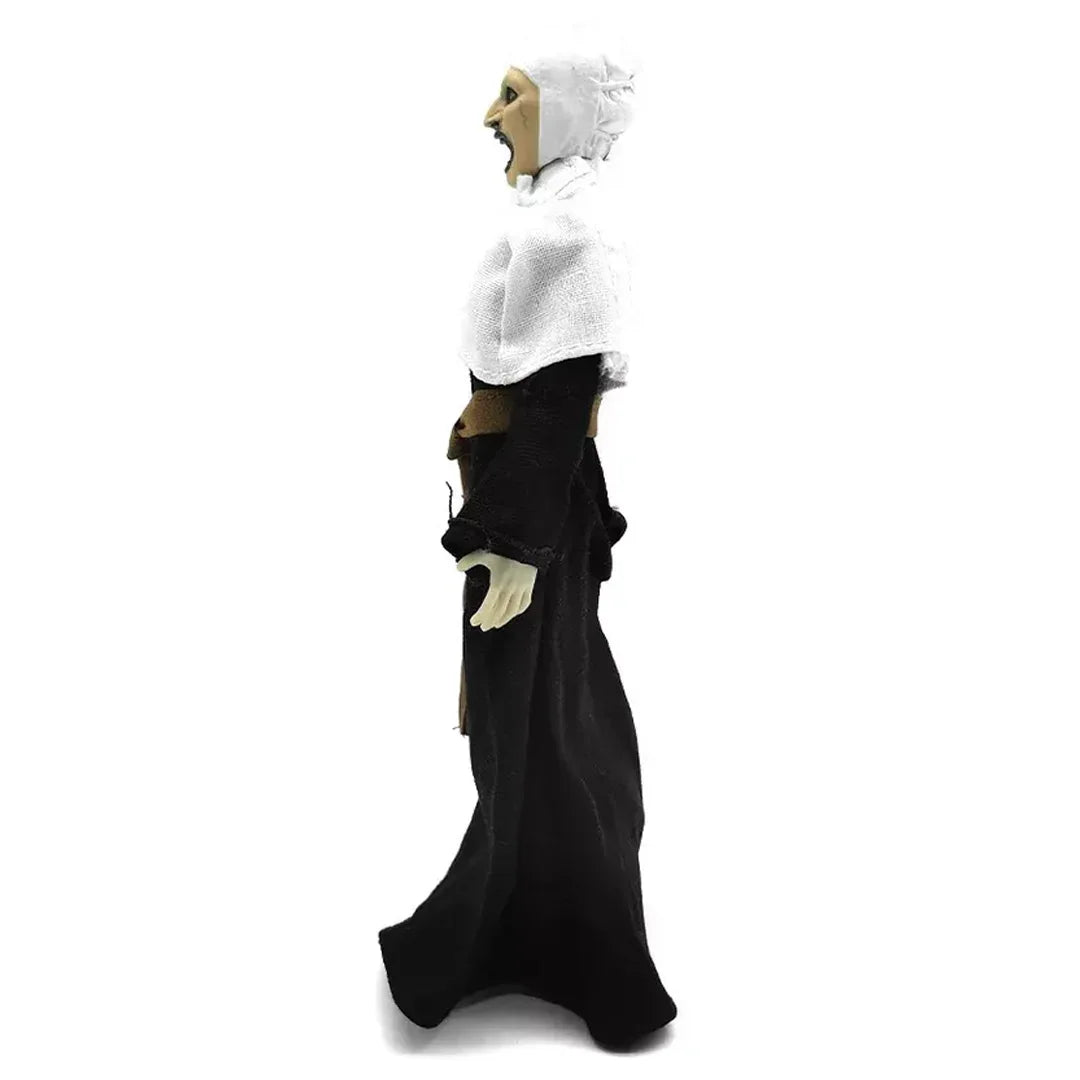 Side view of collectible action figure in black robe and white bonnet, isolated on white