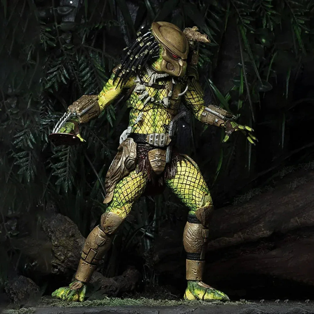 Detailed action figure of armored alien creature posed in jungle setting with realistic foliage.