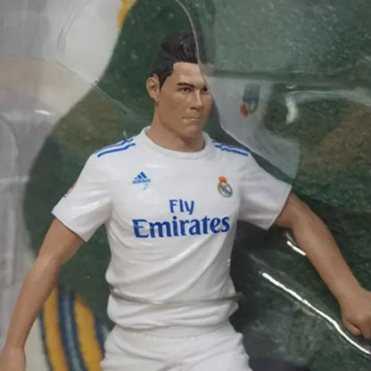 Soccer player action figure in white Real Madrid jersey with Fly Emirates logo