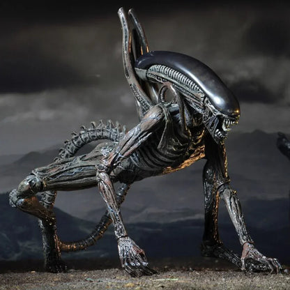 Detailed alien creature action figure with elongated head and tail in a crouching pose