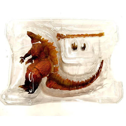 Dinosaur action figure toy in clear plastic packaging with detachable tail and hands.