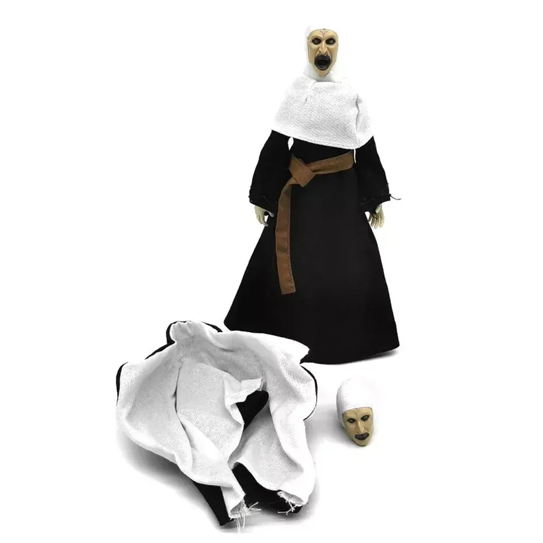 Creepy nun action figure with black robe, white scarf, and interchangeable head on white background