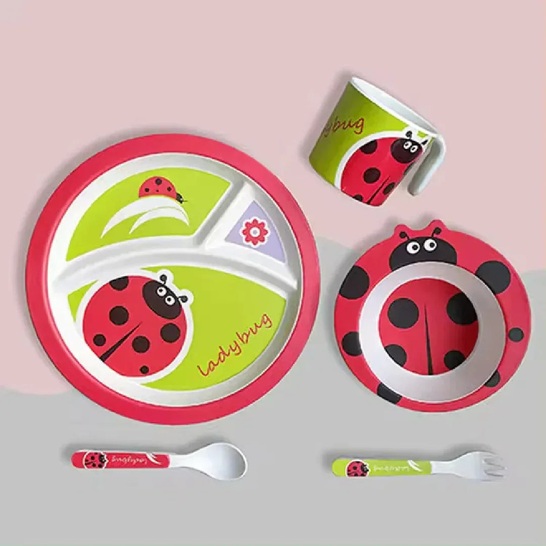 Colorful ladybug-themed kids dinnerware set with divided plate, bowl, cup, spoon, and fork on pastel background.