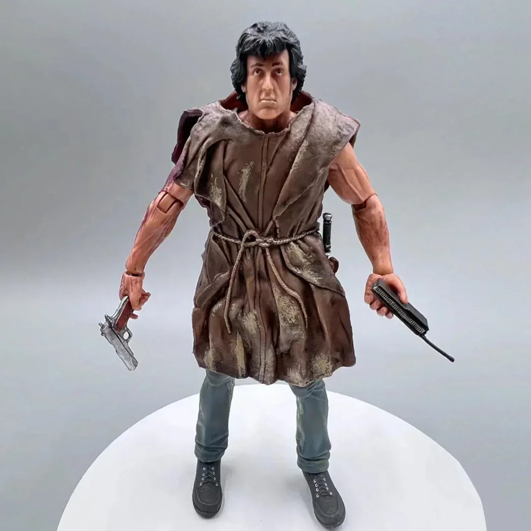 Action figure of muscular man with short black hair, tattered brown robe, and weapons in hand.
