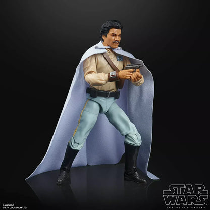Star Wars action figure wearing a beige shirt, blue pants, white cape, holding a blaster.