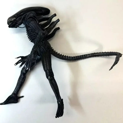 Black alien action figure collectible toy with long tail on white background