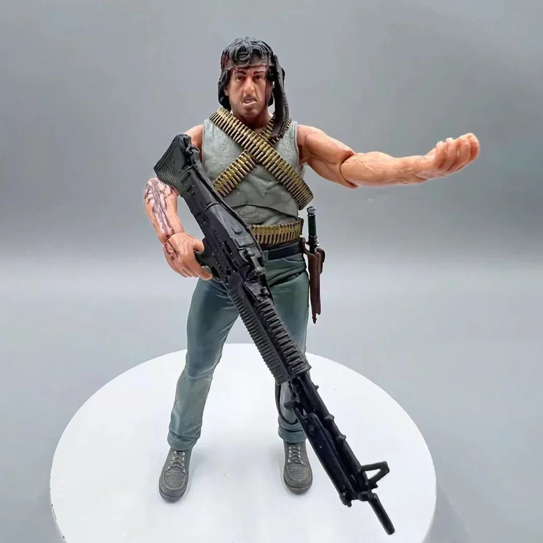 Action figure of a muscular soldier with bandolier, headband, and large rifle on display stand