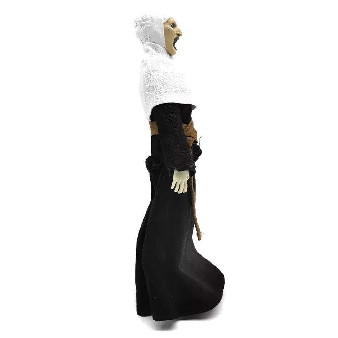 Collectible action figure in black and white robe with open mouth, side view on white background