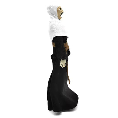 Collectible action figure in black and white robe with open mouth, side view on white background