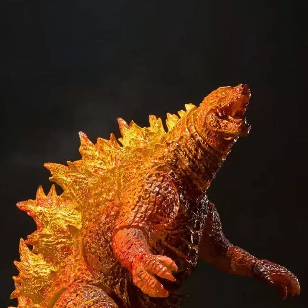 Glow effect monster action figure with orange and yellow spikes, collectible toy on dark background