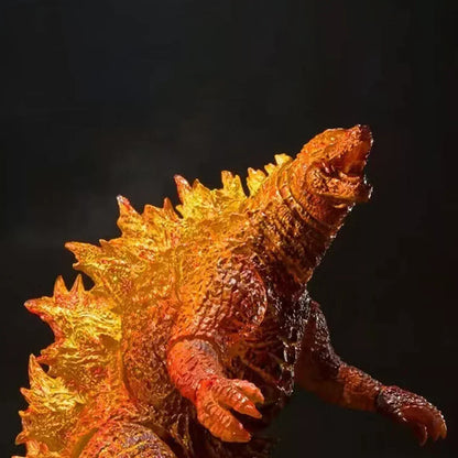 Glow effect monster action figure with orange and yellow spikes, collectible toy on dark background