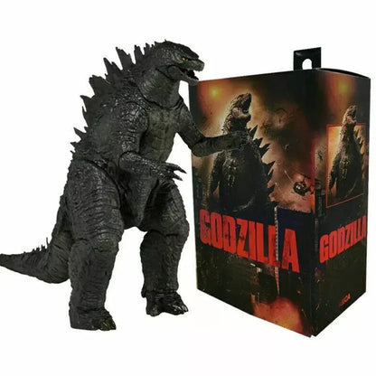 Godzilla action figure next to illustrated Godzilla packaging, collectible monster toy