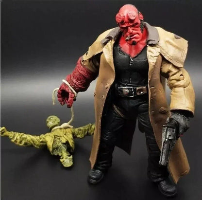 Hellboy action figure holding a pistol and rope, standing beside a defeated enemy toy
