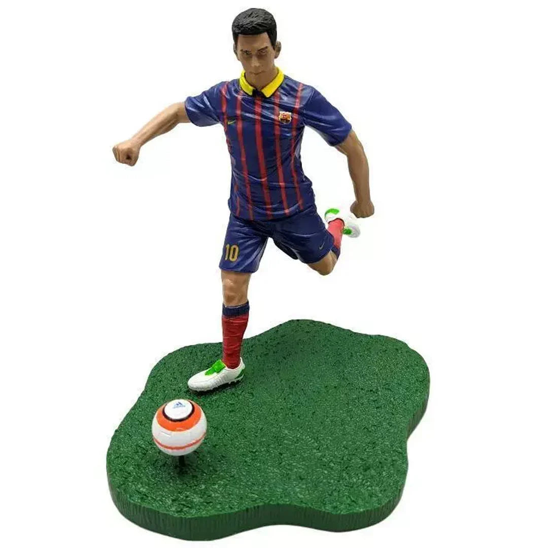 Soccer player action figure in striped jersey kicking a ball on grass base collectible toy