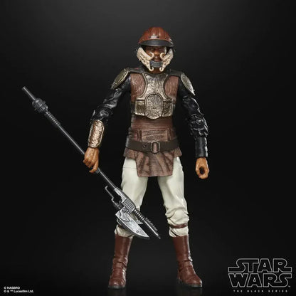 Star Wars action figure in brown armor with helmet and staff against black background