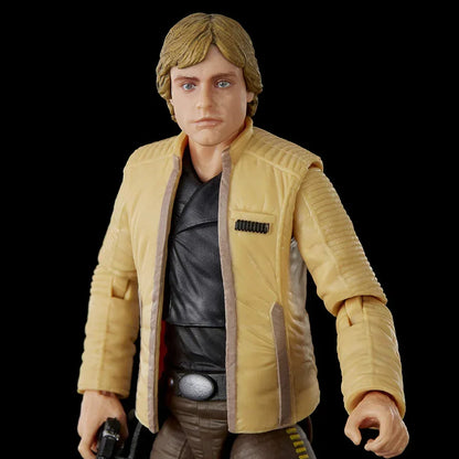Action figure of a blond male character in a yellow jacket, collectible toy on black background.
