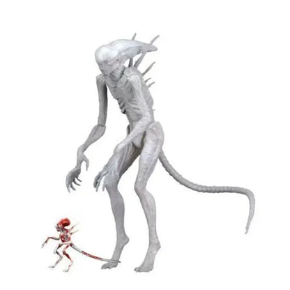 Two articulated alien action figures, one large white creature and one small red alien, on white background.