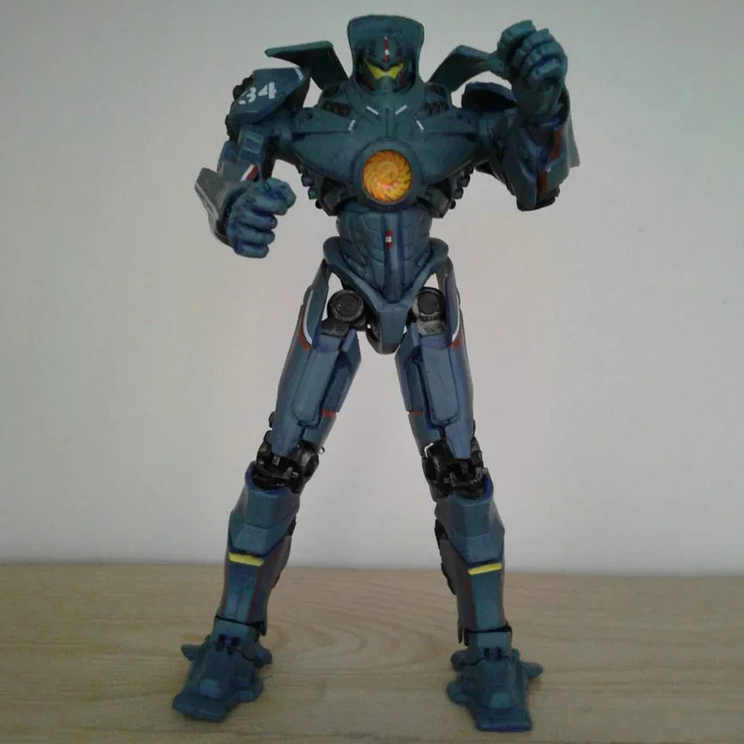 blue robot action figure toy with glowing chest detail on a wooden surface