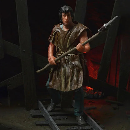 Realistic action figure holding a spear, wearing a rugged tunic, posed in a dark, dramatic setting