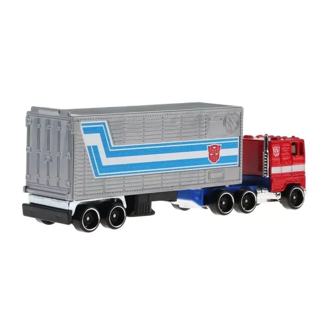 Die-cast toy truck with red cab, silver and blue trailer, collectible action figure vehicle